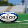 Rugby ball on pitch women's sport