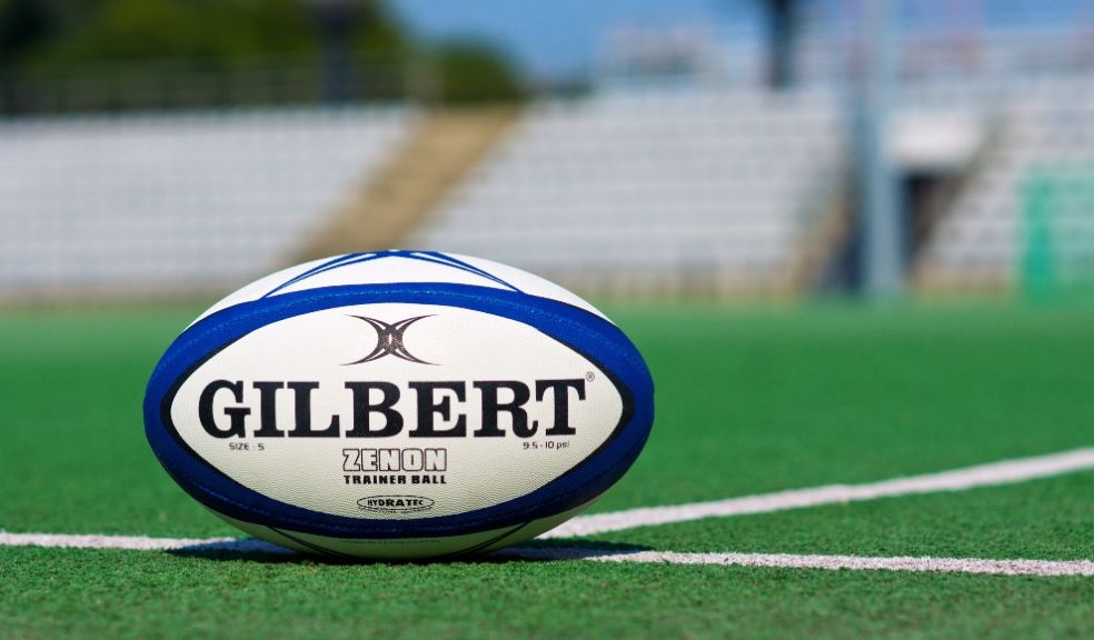 Rugby ball on pitch women's sport