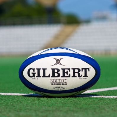 Rugby ball on pitch women's sport