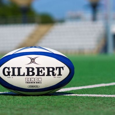 Rugby bal on pitch women's sport